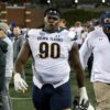 Ex-NFL star who squatted 700lbs lands devastating 11-second KO to become an MMA champion